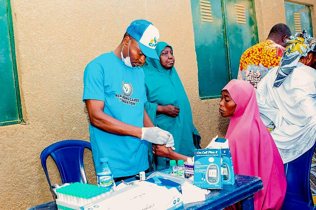 A medical volunteer testing patients at a free medical outreach